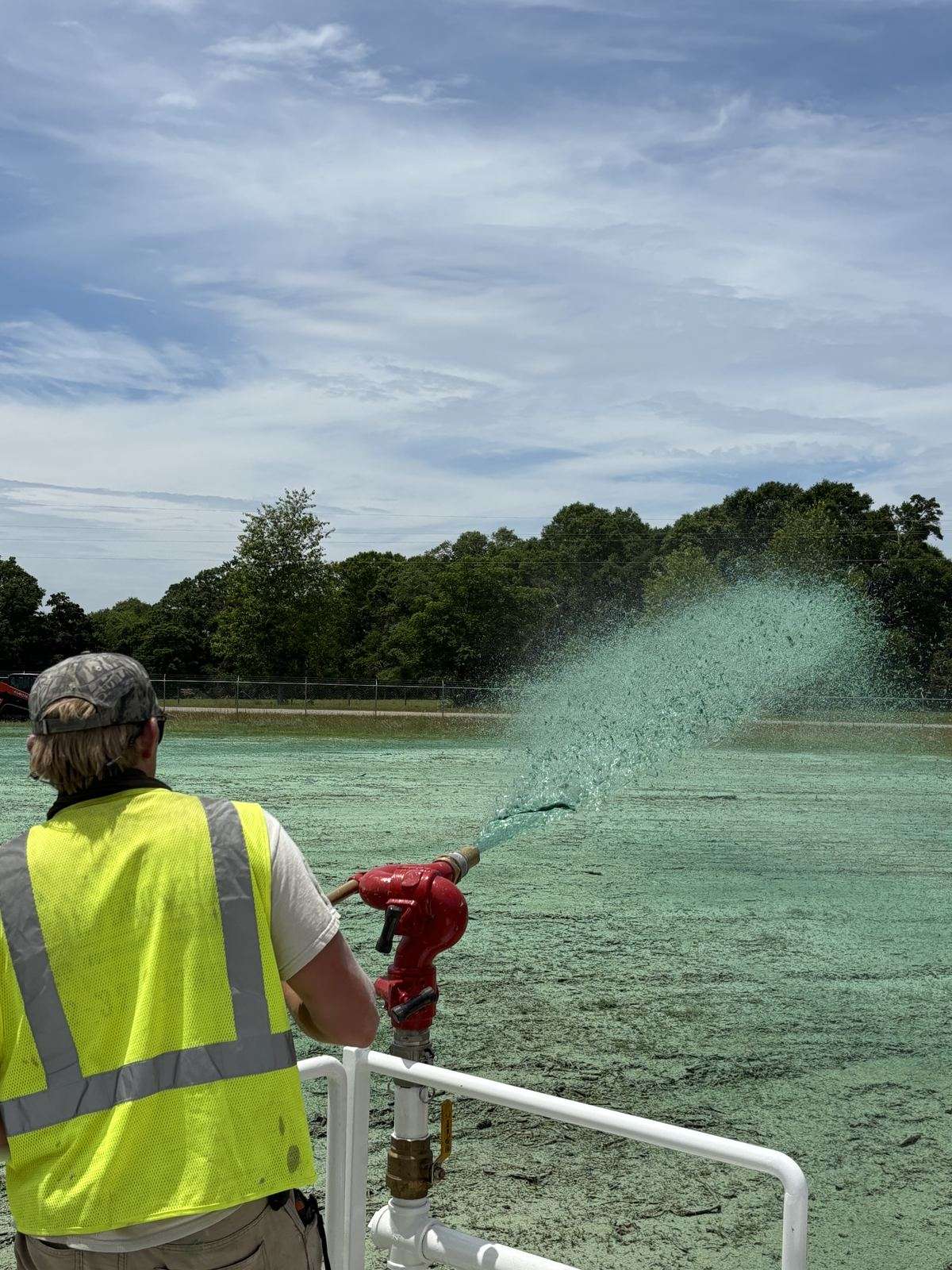 Operator spraying hydromulch with the TurfMaker 2200 deck cannon