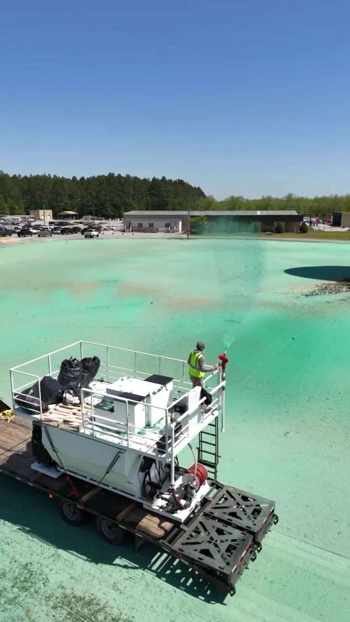 Aerial view of the TurfMaker 2200 hydroseeder spraying hydromulch from its deck